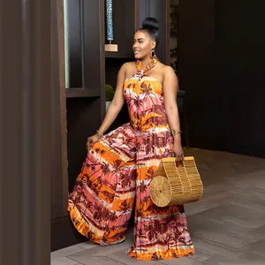Close-up of vibrant tropical palm tree print on a stylish halter neck wide-leg jumpsuit.