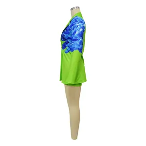 Side profile detail of vibrant green women's suit set with blue floral print sleeves