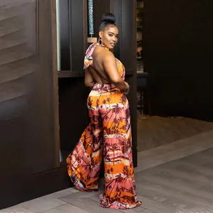 Close-up of backless halter-neck jumpsuit with tropical palm tree print