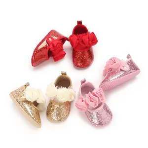 Detailed view of sparkly glitter baby toddler shoes featuring large 3D fabric flower decor.