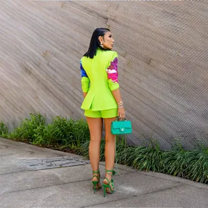 Back view of neon green blazer set with floral printed sleeves and matching shorts