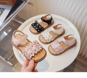 Detail view of girls' floral summer sandals in pink, white, and black