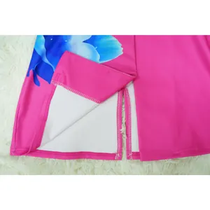 Macro detail showing the hemline and side slit of a hot pink floral print suit set