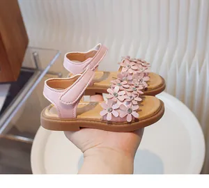 Close-up detail of pink toddler girl sandals featuring sparkling 3D flower decorations
