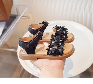 Close-up view of black girls' princess sandals featuring 3D floral and rhinestone details