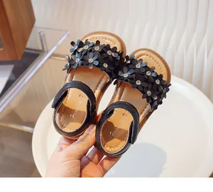 Detailed view of girls' black floral princess sandals with rhinestone accents