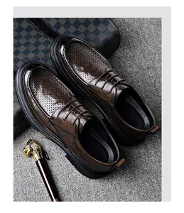 Top view of brown perforated men's business casual shoes with thick soles and laces
