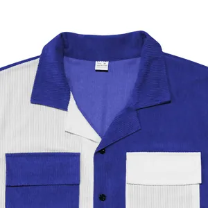 Close-up detail of color-block heavy corduroy short-sleeve shirt with lapel collar and pockets