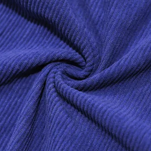 Detailed macro shot of premium deep blue corduroy fabric texture and ribbed pattern.