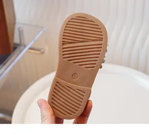 Detail of durable non-slip rubber sole on kids' sandals featuring embossed size 23