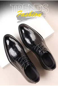 Detailed top view of black Brogue shoes featuring polished alligator leather texture