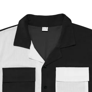 Close-up of black and white color-block corduroy shirt with lapel and pockets.