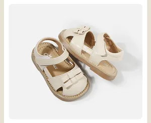 High-quality detail of beige toddler sandals with a cute bow and secure Velcro strap