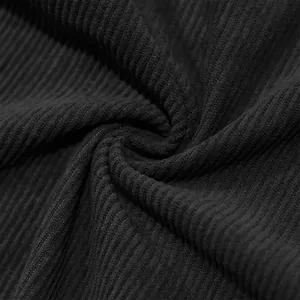 Detailed macro shot showing the vertical ribbing and texture of black corduroy fabric