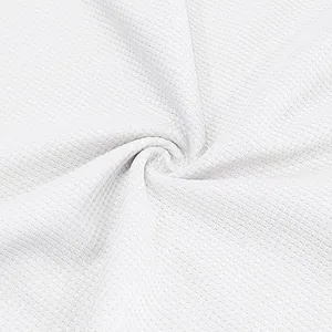 Detailed macro shot of white waffle weave fabric texture showing the material pattern.