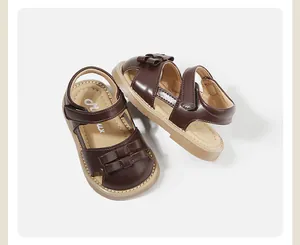 Detail view of brown toddler girl leather sandals with cute bow decoration