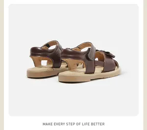 Detailed back view of brown faux leather baby girls' sandals with velcro strap