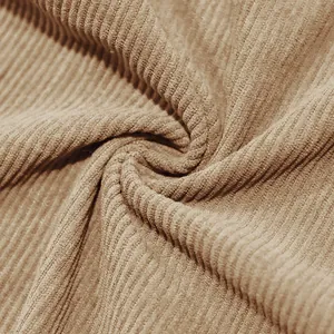 Close-up macro of premium heavyweight khaki corduroy fabric with clear ribbed texture.