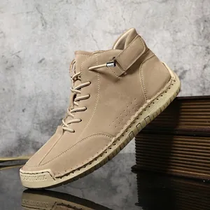 Detailed shot of hand-stitched khaki suede high-top Martin boots with side buckle