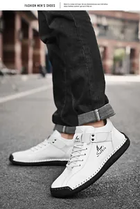 Close-up of white men's leather shoes with hand-stitched detailing and Salkin logo