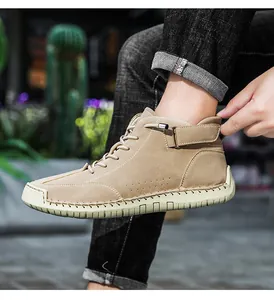 Detail view showing the fine handmade stitching on these men's khaki high-top Martin boots.