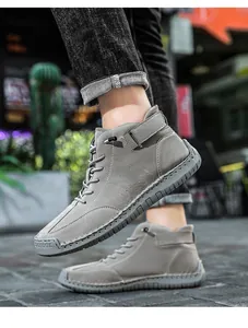 Macro view showing the detailed hand-stitched texture of grey high-top men's Martin boots