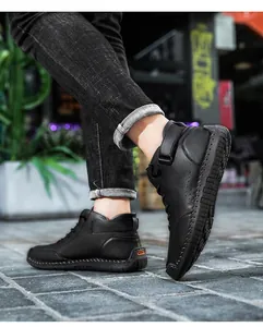 Close-up of black high-top Martin boots featuring hand-stitched sole detail