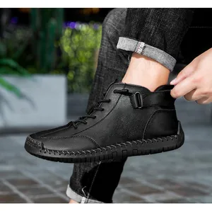 Side detail of black hand-stitched men's high-top Martin boots with velcro strap