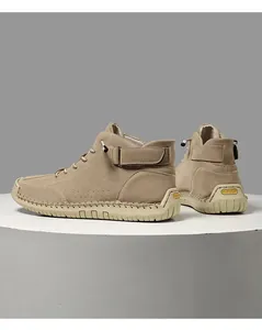 Side and rear view of beige hand-stitched high-top men's casual boots on display
