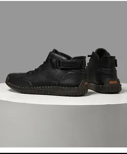 Detailed rear and side view of black hand-stitched high-top Martin boots for men
