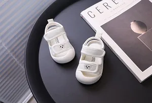 Close-up of breathable mesh baby sandals with cute bear embroidery on the strap
