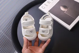 Detailed view of white breathable mesh baby sandals featuring a cute bear pattern