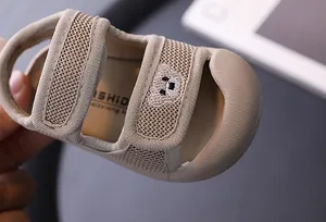 Close-up of breathable mesh baby sandal with cute bear embroidery and velcro strap.