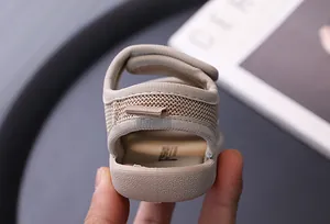 Macro view showing the breathable mesh texture and soft heel of beige baby sandals