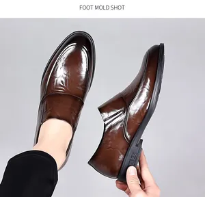 Detailed shot of brown polished leather loafers for men's formal business wear.