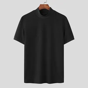 Detail view of men's black ripple textured knit T-shirt featuring a mock neck collar