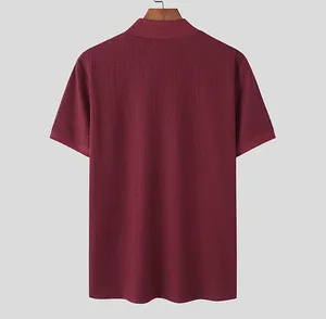 Back view detail of burgundy men's knit polo shirt featuring textured water ripple fabric