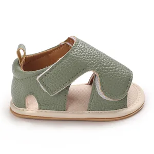 Side view of green textured leather baby walking sandal with velcro strap