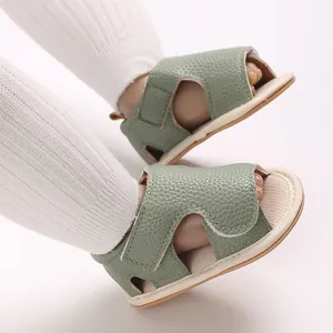 Detail view of sage green faux leather baby sandals with adjustable velcro strap.