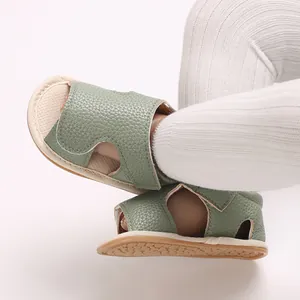 Close-up of sage green infant soft-sole leather sandals for baby boys