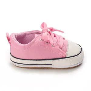 Detailed profile view of pink canvas infant pre-walker baby shoes with soft soles