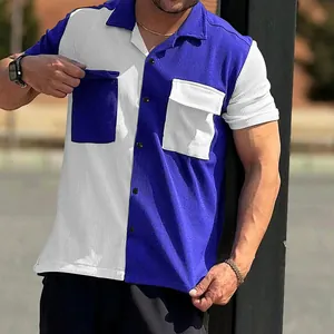 Detail view of men's blue and white color-block shirt with corduroy texture.