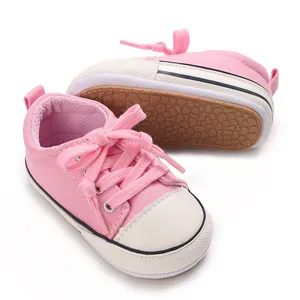 Detailed view of pink baby soft sole canvas sneakers with anti-slip patterned rubber bottom