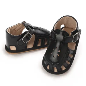 Close-up detail of black baby girl sandals with soft sole and cute flower cutouts