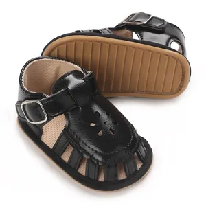 Macro view of flexible brown soft sole and black leather upper with flower cutout details