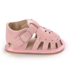 Close-up detail of pink baby girl walking sandals featuring delicate floral cutouts