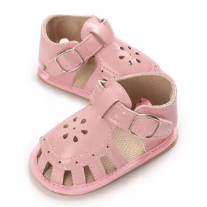 Pink leather baby sandals with laser-cut floral pattern and soft sole for infant girls