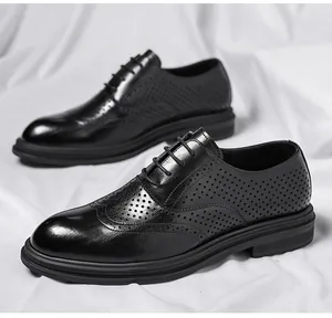 Close-up of black perforated Brogue shoes with height-increasing thick soles