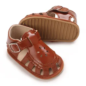 Detailed view of brown baby girl sandals with flower cutouts and soft non-slip soles