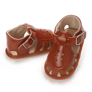 Detail shot of brown baby girl walker sandals with hollow flower pattern and soft sole.